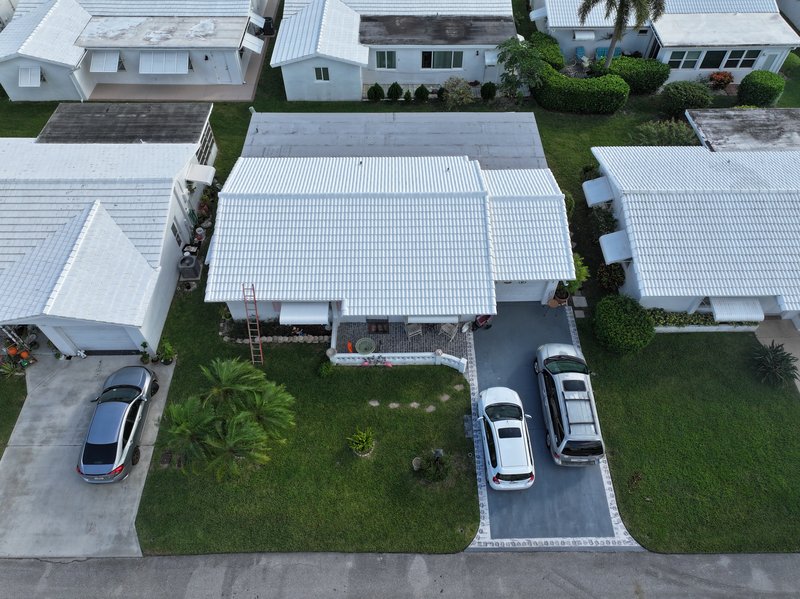 Aerial view of South Florida homes with flat white membrane roofs